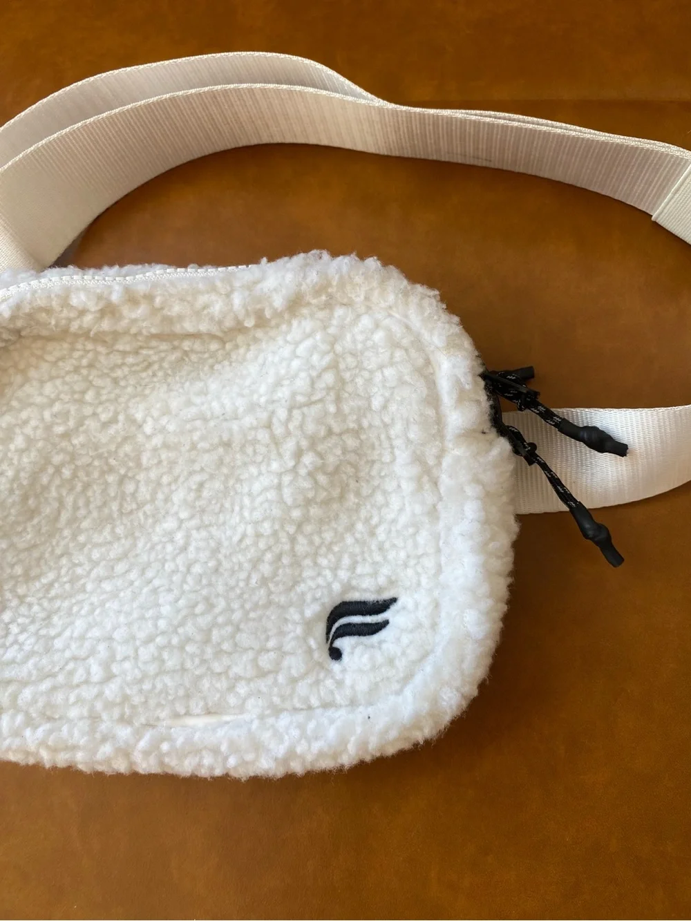 Fabletics The Belt Bag Teddy in color Bone Sherpa Crossbody Bag with Wide Strap